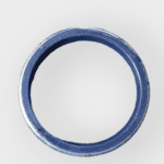 A close-up of the Case Construction 83931281 seal for backhoe bucket pin, showing its size and shape.